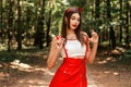 Fresh portrait gorgeous pretty young woman with red lipstick and sexy lips in white youth top in red fashionable sundress in