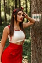 Fresh portrait gorgeous pretty young woman with red lipstick and sexy lips in white youth top in red fashionable sundress near