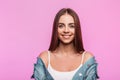 Fresh portrait positive young woman with charming smile in fashionable blue denim jacket in vintage white t-shirt near pink wall Royalty Free Stock Photo