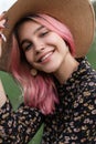 Fresh portrait pretty cheerful young woman with perfect positive smile with pink hair in fashionable straw hat in stylish black Royalty Free Stock Photo