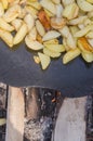 Fresh potato boiled in large restaurant frying pan. Picnic healthy food cooking at large metallic pan