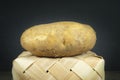 Fresh potato on a tipped wicker basket