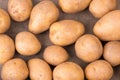 Fresh potatoes on a brown textured background Royalty Free Stock Photo