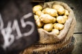 Fresh potatoes in burlap sack selling in market Royalty Free Stock Photo