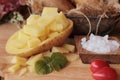 Fresh potatoes for cooking on wood background. Royalty Free Stock Photo