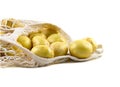 Fresh potatoes in a string bag on a white background. Royalty Free Stock Photo