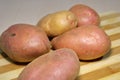 Fresh potatoes on a wooden board.