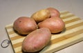 Fresh potatoes on a wooden board.