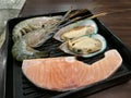 Fresh prawn , Mussel and salmon on the ice and the supermarket with blur background, Freshness Japanese seafood meat for BBQ, focu