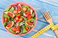 Fruit and vegetable salad with fork and tape measure, healthy lifestyle, diet, slimming and nutrition concept Royalty Free Stock Photo