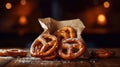 fresh pretzels with sea salt in a paper bag on top an old wooden table