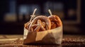 fresh pretzels with sea salt in a paper bag on top an old wooden table Royalty Free Stock Photo