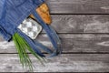 Fresh produce in blue denim market bag on wooden background, flat lay. Eco friendly reusable shopping bag for minimize waste,