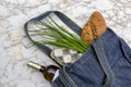 Fresh produce in blue denim market bag on wooden background, flat lay. Eco friendly reusable shopping bag for minimize waste,