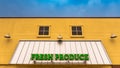 Bright Green Fresh Produce Sign on a Yellow Store Front