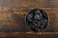 Fresh prunes in wooden bowl. Dried plums