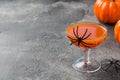 Fresh pumpkin juice. Concept Halloween celebration. Background of spider web