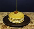 Fresh pure honey on Scotch pancakes.