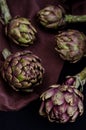 Fresh purple artichokes on black background Royalty Free Stock Photo