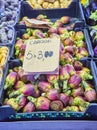 Fresh purple Artichokes in a market with a cartel in Italian showing the price Royalty Free Stock Photo