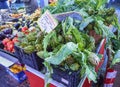 Fresh purple Artichokes in a market with a cartel in Italian showing the price Royalty Free Stock Photo