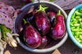 Fresh purple eggplant in metal basin on the market. Close-up view of raw aubergine with water drops. Vegan food Royalty Free Stock Photo