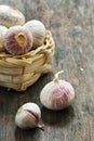 Fresh purple garlic in a small straw basket Royalty Free Stock Photo