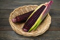 Fresh purple organic corn in basket on wooden table background Royalty Free Stock Photo