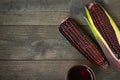 Fresh purple organic corn with juice on wooden table background Royalty Free Stock Photo