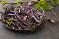 Fresh purple string beans on a black table, clean eating,selective focus.