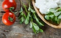 Fresh purslane Portulaca oleracea, edible weeds with yoghurt and cherry tomatoes on wooden table