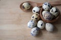 Fresh quail eggs in a wooden bowl on a wooden table background Royalty Free Stock Photo