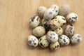 Fresh quail eggs on wooden table background. Pile of quail eggs on the table Royalty Free Stock Photo