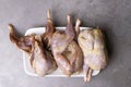 some plucked quails ready for cooking on a white background