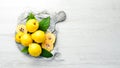 Fresh quince fruits on a wooden board. Top view.