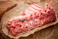 Fresh rack of raw pork spare ribs seasoned with spices on slate tray with leaves at background, Horizontal composition with copy Royalty Free Stock Photo