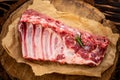Fresh rack of raw pork spare ribs seasoned with spices on slate tray with leaves at background, Horizontal composition with copy Royalty Free Stock Photo