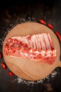 Fresh rack of raw pork spare ribs seasoned with spices on slate tray with leaves at background, Horizontal composition with copy Royalty Free Stock Photo