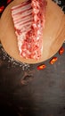 Fresh rack of raw pork spare ribs seasoned with spices on slate tray with leaves at background, Horizontal composition with copy Royalty Free Stock Photo