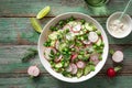 Fresh radish, cucumber and green peas salad in white bowl Royalty Free Stock Photo