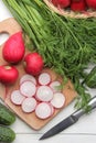 Fresh radish. Spring fresh vegetables radishes, cucumber, green onions and greens on a white wooden table. ingredients for cooking Royalty Free Stock Photo