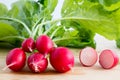 Fresh radishes, Raphanus sativus, on wooden plate