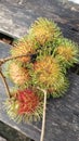 Fresh Rambutan Fruits on Rustic Wooden Table. Royalty Free Stock Photo