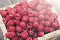 Fresh raspberries basket on brown rustic wood background Royalty Free Stock Photo