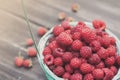 Fresh raspberries basket on brown rustic wood background Royalty Free Stock Photo