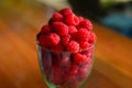 Fresh raspberries in a glass on the table. Healthy and vitamine food