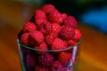 Fresh raspberries in a glass on the table. Healthy and vitamine food