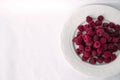 Fresh raspberries in a white plate