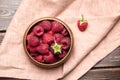 Fresh raspberries in wooden bowl on brown table. Red ripe raspberries, sweet berries Royalty Free Stock Photo