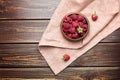 Fresh raspberries in wooden bowl on brown table. Red ripe raspberries, sweet berries Royalty Free Stock Photo